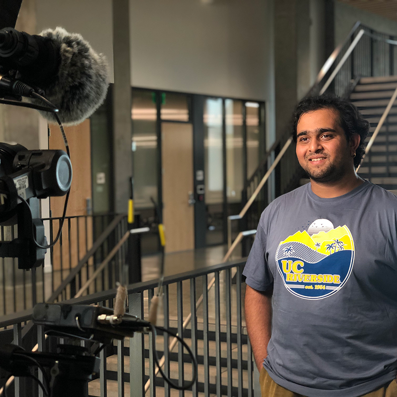 UCR alum, Dev Bhatt, looks into a camera for a segment interview on an episode of the 'The College Tour'