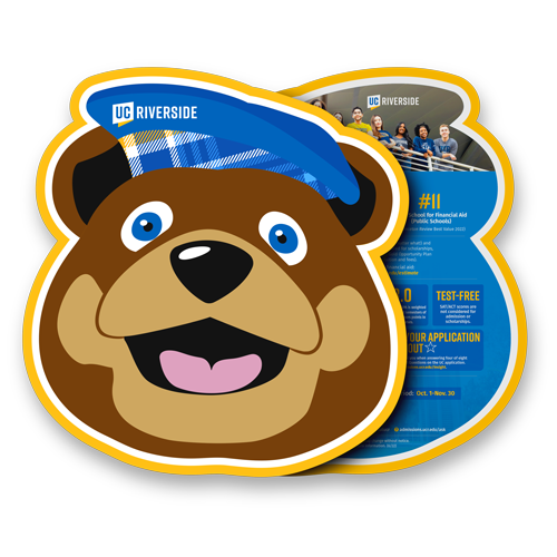 A brochure in the shape of UCR's mascot Scotty the Bear. The front shows an illustration of Scotty and the reverse side is partially shown and is filled with UCR facts, deadlines and statistics.
