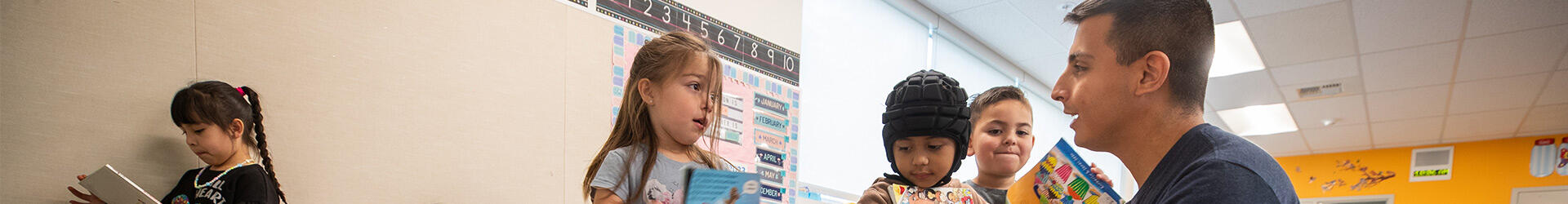 School teacher speaking with children